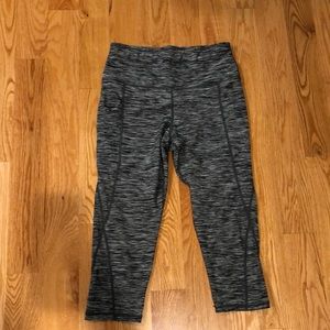 Gray/black Capri workout pants with pockets on both sides.